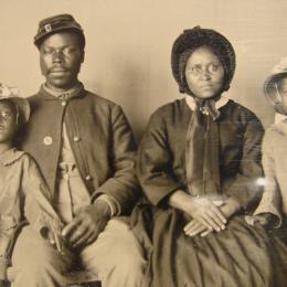 Unidentified African American soldier in Union uniform with wife and two daughters